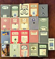 Twenty card decks laid out 5×4 showing fronts of boxes with varied casino branding