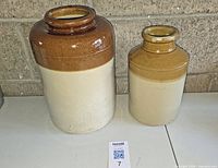Two stoneware crocks showing size difference and glazing