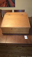 Closed pine tabletop clerk's desk on dining table
