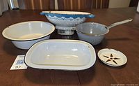 Group shot of all five enamelware pieces on table