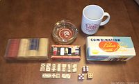 Overview of mug, ashtray, poker chips sets, dice and dominoes
