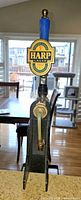 Front view of Harp Lager beer tap showing badge, handle, faucet and hose