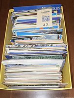Yellow box filled edge-on with hundreds of postcards