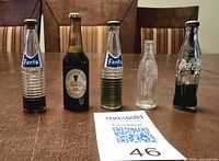 Front view of all five miniature bottles lined on table