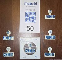 Front view showing six Kennedy collar clips with auction sheet