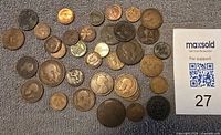 Top-down view showing full group of approx. 35 mixed copper coins
