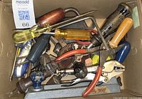 Box view showing mixture of screwdrivers, brace drill, pliers, locking pliers and miscellaneous small tools