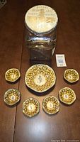 Full lot showing glass jar with lid and seven bowls