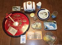 Overview of all fourteen Niagara Falls souvenir items laid on table