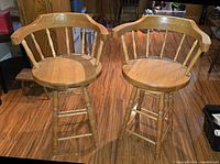 Front view of two solid oak swivel stools