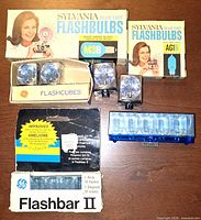 Group shot of boxed flashbulbs, flashcubes and flashbar