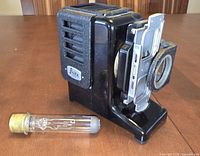 Front and side view of Leitz slide projector with spare bulb