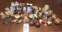 Overall view of entire lot of salt and pepper shakers
