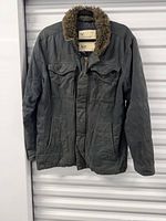 Front view of coat showing overall style, color and pockets