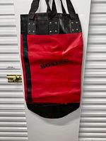 Full view of red and black vinyl punching bag