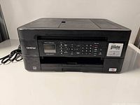 Front view of Brother MFC-J497DW printer showing control panel and exterior condition