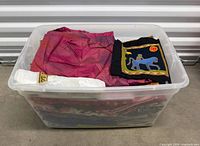 Plastic bin filled with assorted fabrics