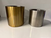 Gold-tone and stainless steel ice buckets side by side
