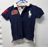 Front view of navy Polo Ralph Lauren kids shirt on hanger