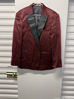 Front view of red jacquard blazer on hanger