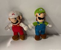 Front view of both Mario and Luigi plush toys standing side by side