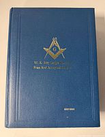 Front cover showing blue binding, gold Masonic emblem, lodge name and Holy Bible title