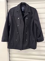 Front view of black double-breasted pea coat