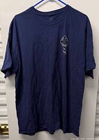 Full front view of navy Jerzees T-shirt on hanger