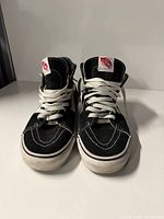 Front view of both sneakers showing uppers, laces, toe caps