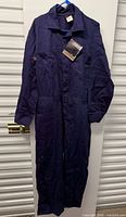 Full view of navy blue coverall hanging