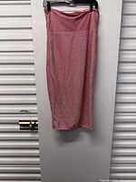 Full view of pink strapless glitter dress hanging