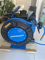 Front view of Mastercraft compressor showing hose reel and branding