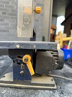Side view showing tilting worktable, angle gauge, motor housing