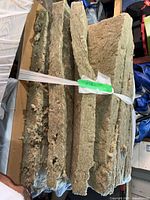 Stack of mineral wool batts bound with plastic strap