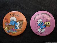 Front view of both Smurf buttons showing graphics and slogans