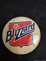 Front view of Toronto Blizzard button displaying logo and discoloration