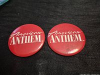 Front view of both red American Anthem buttons