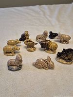 Grouped view of 11 animal figurines showing variety and glaze colours