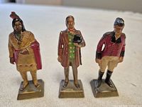 Three sample figurines showing detail, bases with names