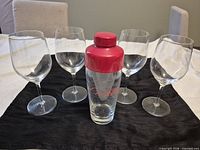 Group view of four wine glasses with assembled cocktail shaker