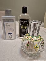 Lamp and two oil bottles grouped