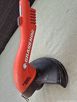 Close view of Grass Hog head and guard showing branding and 12" marking