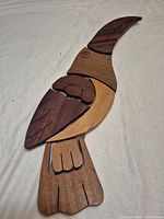 Front view of segmented multi-wood bird showing color variations and overall design