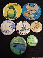 Front view of all seven animal-themed buttons