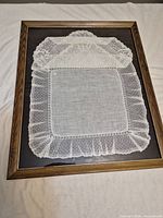 Full view of framed lace handkerchief