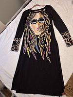 Front view of black long-sleeve Rock N Karma dress with colorful graphic and leopard cuffs