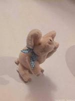 Front angled view of Rudy The Pig showing ribbon and facial details