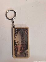 Front view of keychain showing pope waving photo tag and metal ring
