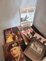 All five war books laid out showing fronts