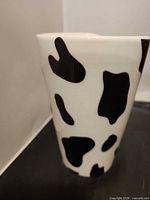 Front view of mug showing cow-spot pattern